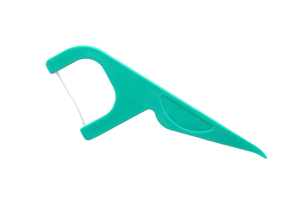 Green plastic dental floss pick flosser