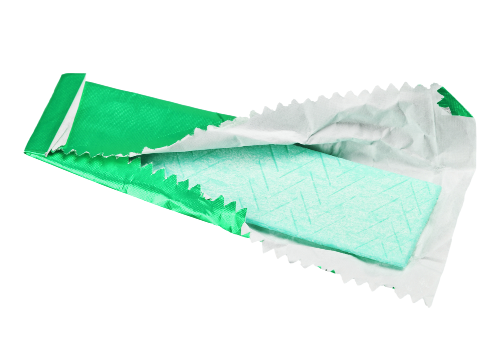 Green gum stick in opened green wrapper