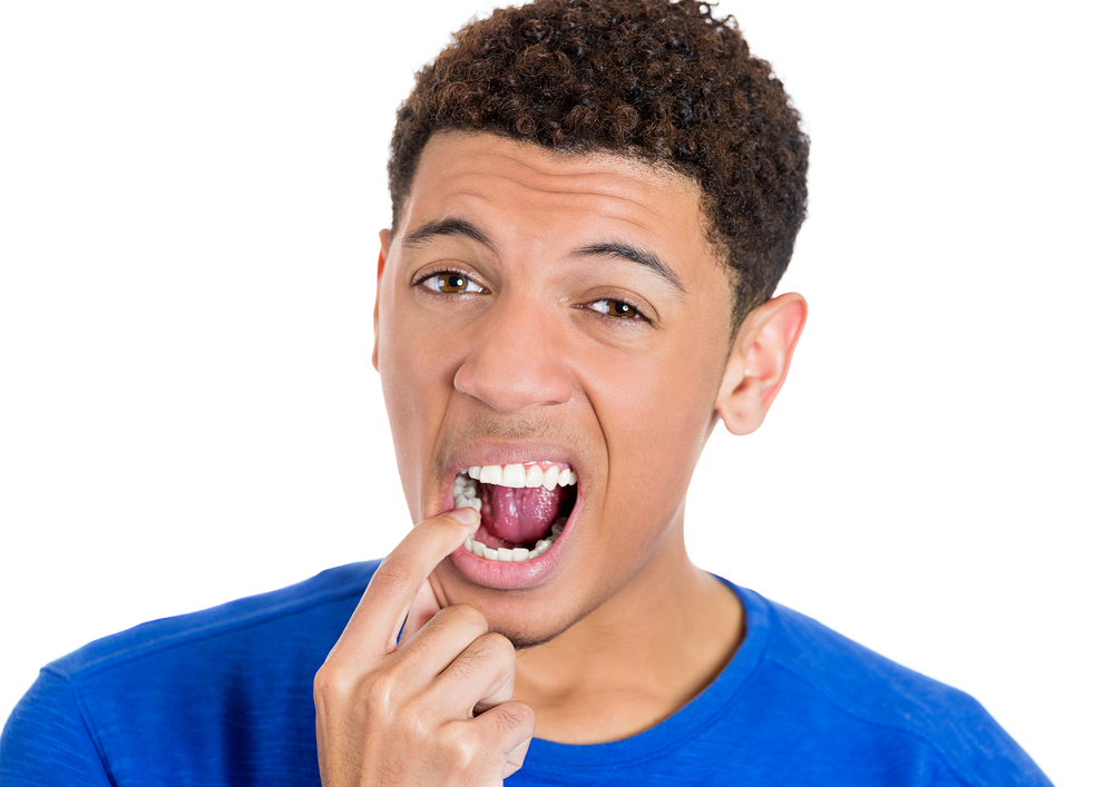 Man pointing to a painful tooth