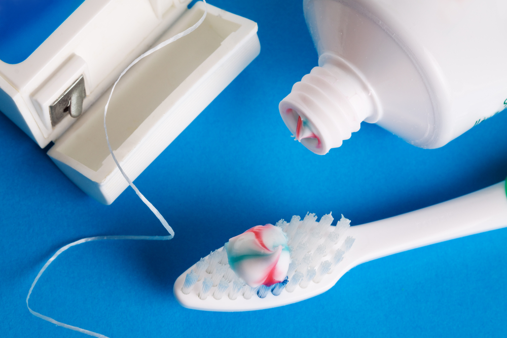 Floss toothbrush and toothpaste
