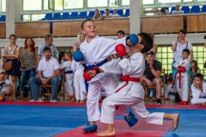 2 boys participating in karate while wearing mouthguards