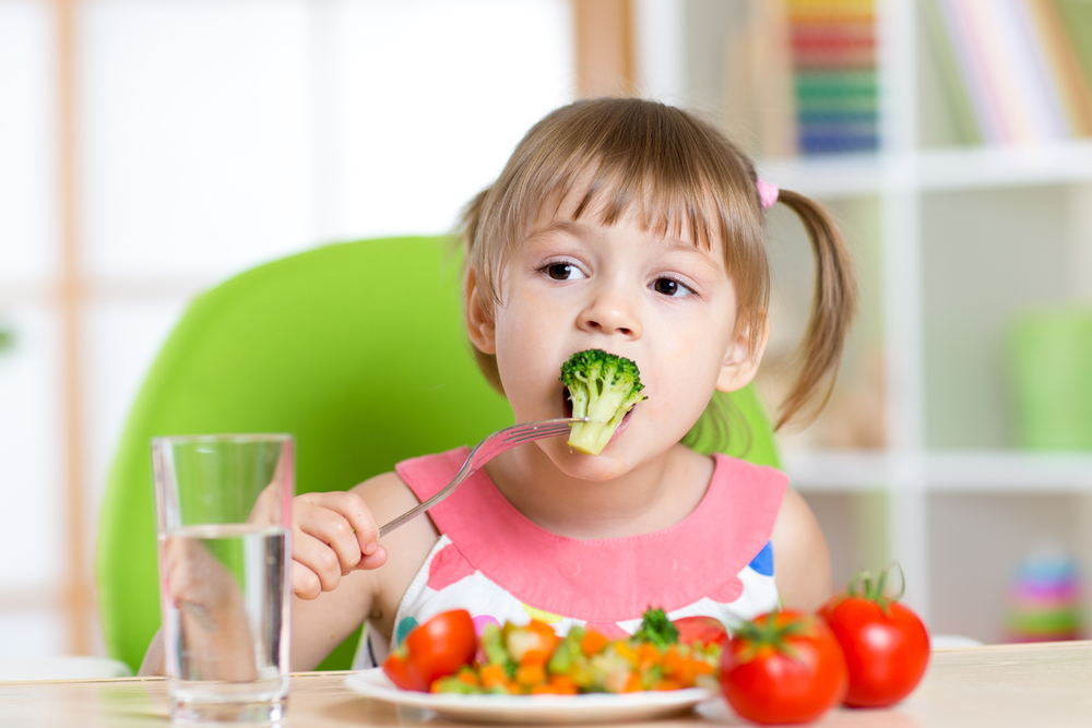 girl eating organic vegetables