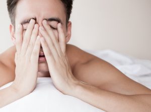 man with OSA showing signs of fatigue as he wakes up