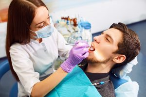 Overview of dental caries prevention. man at the dentist's chair during a root canal procedure