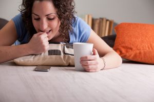 girl nail-biting while she looks at her cell phone