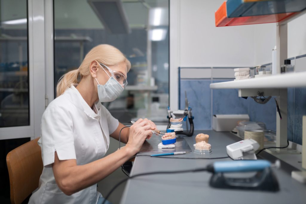 dentist constructing veneers in office