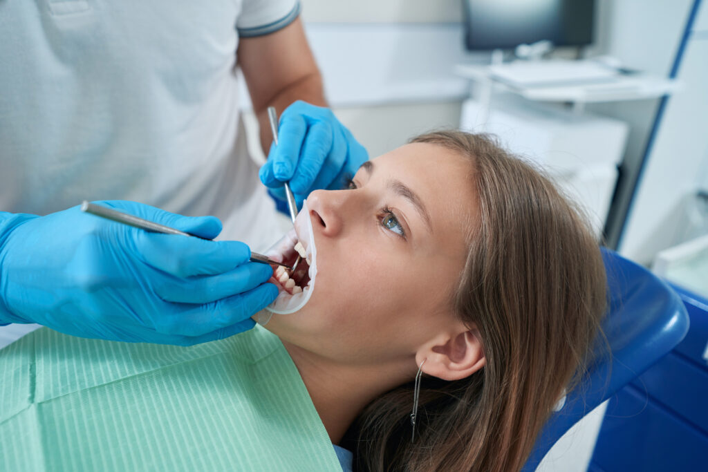 dentist inspecting oral cavity of chilf
