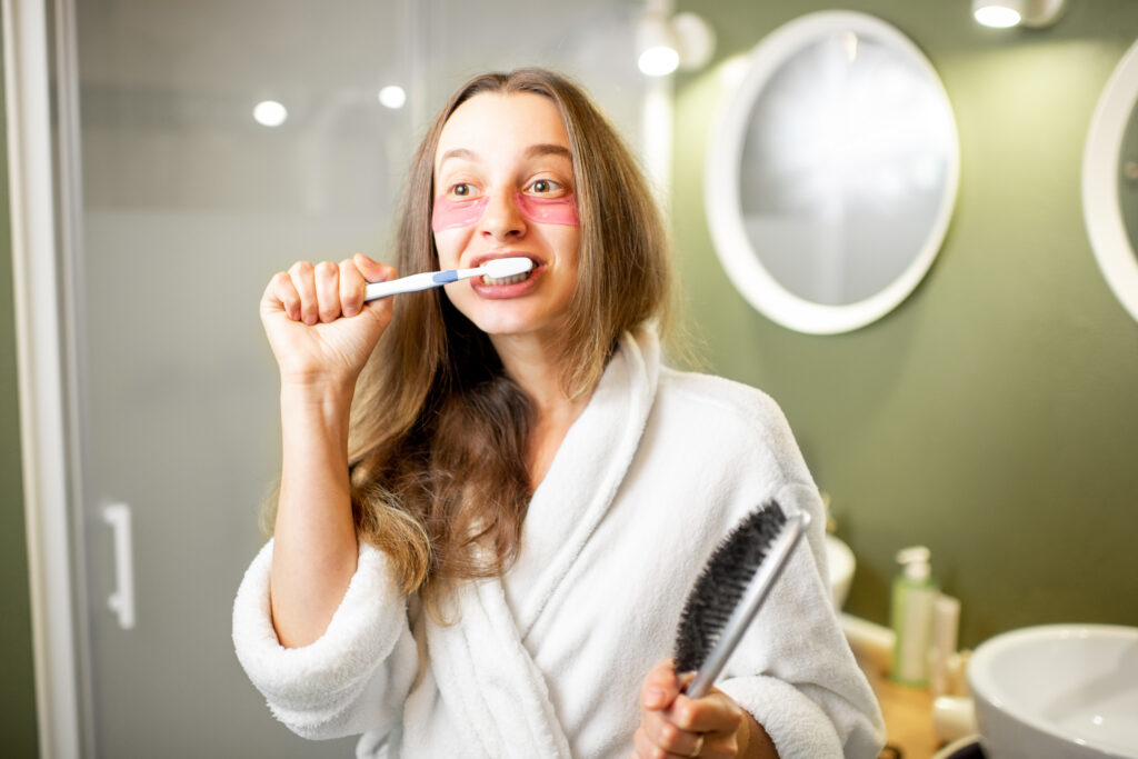 young woman brushing her teeth vigourously