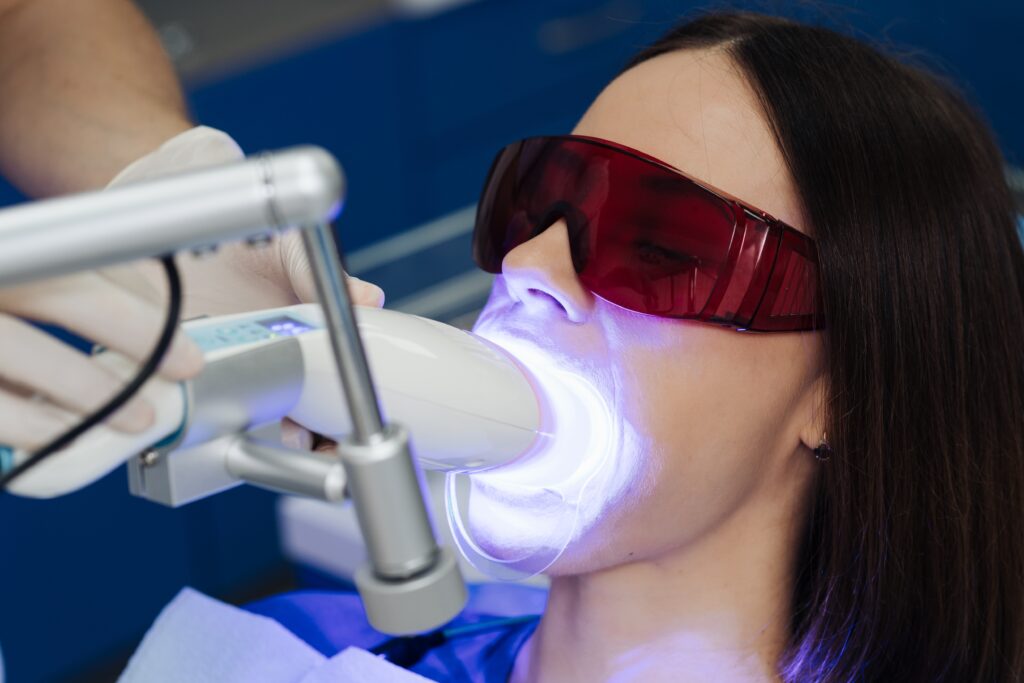 woman having laser teeth whitening procedure