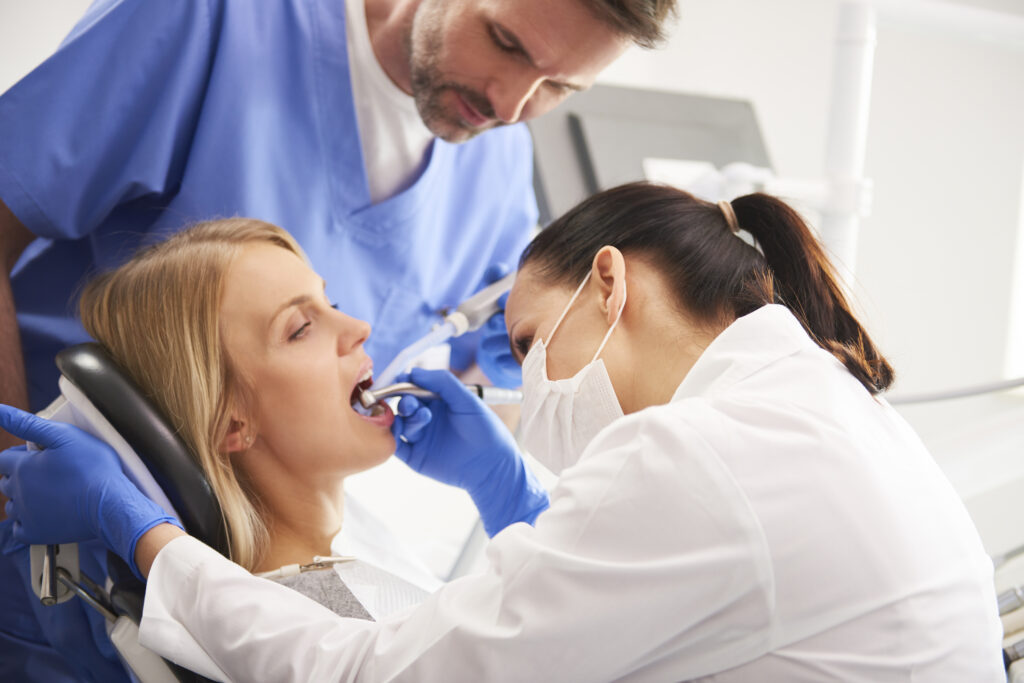 focused dentist treating a cavity