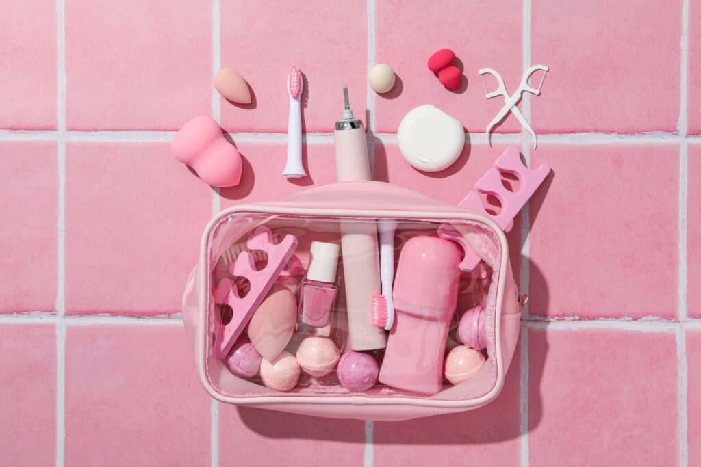 a pink cosmetic bag shown over pink tile background
