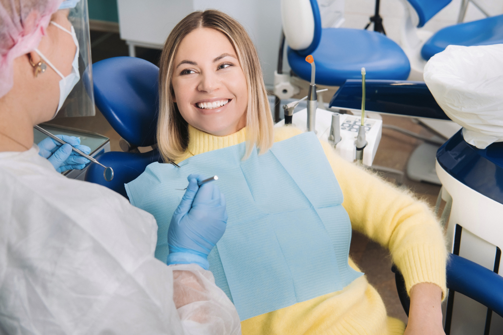 A woman smiles after a painless cavity treatment