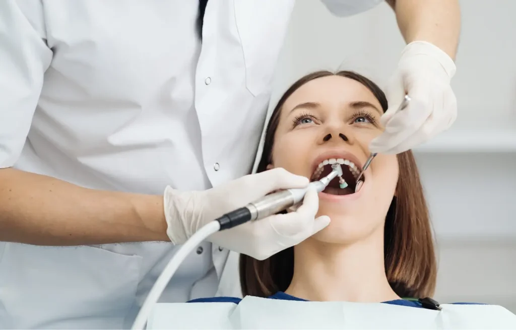 a woman having her teeth professionally cleaned