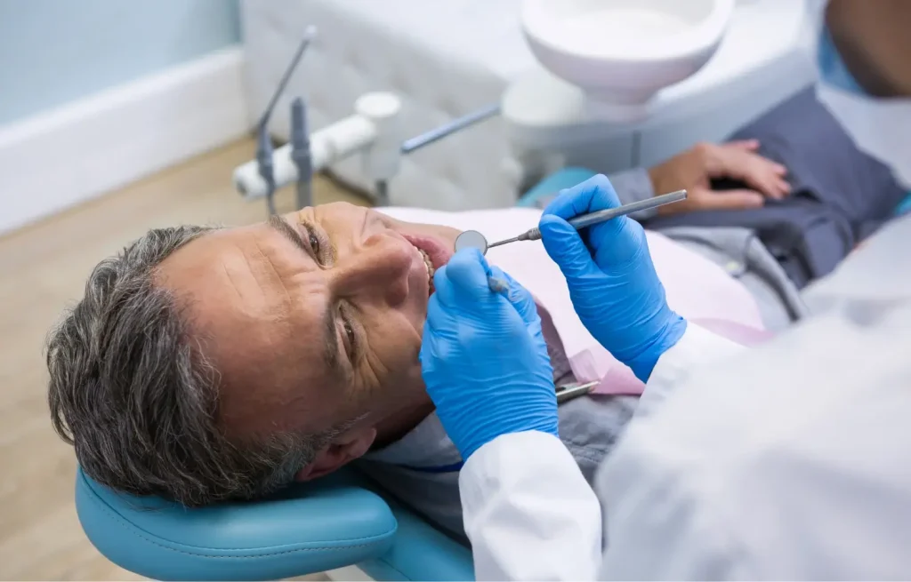 elderly man undergoing dental work