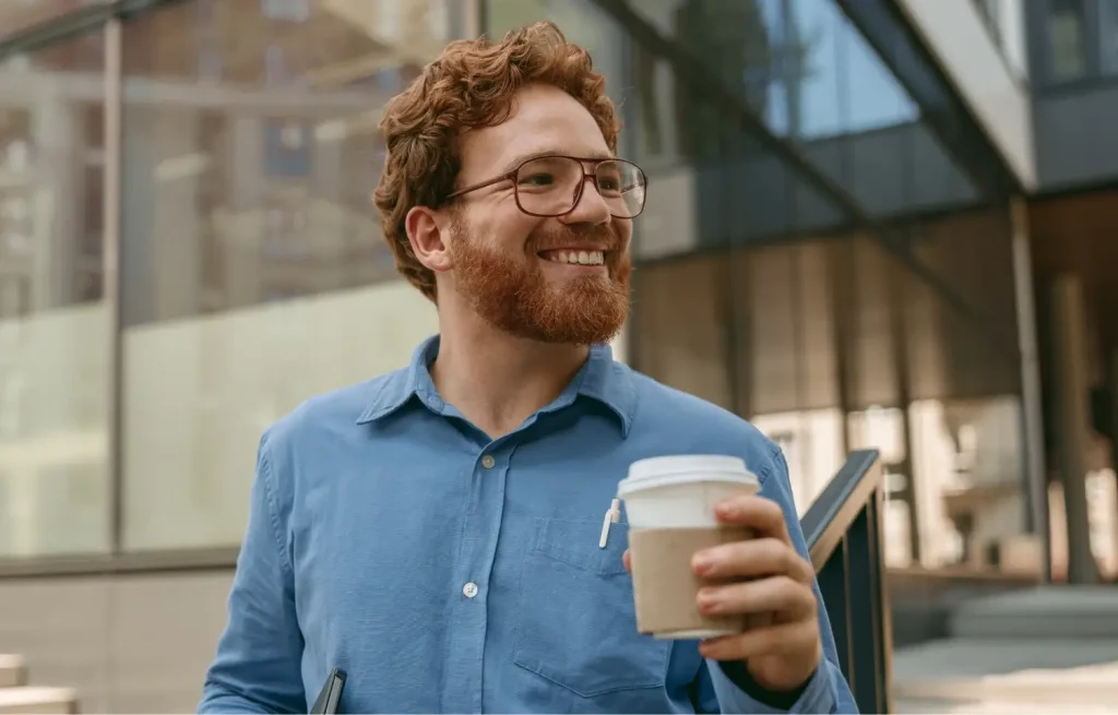 man with good smile drinking coffee