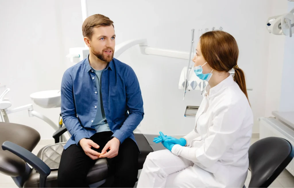 A dentist discussing a tooth extraction plan with a patient, emphasizing preparation and personalized care.