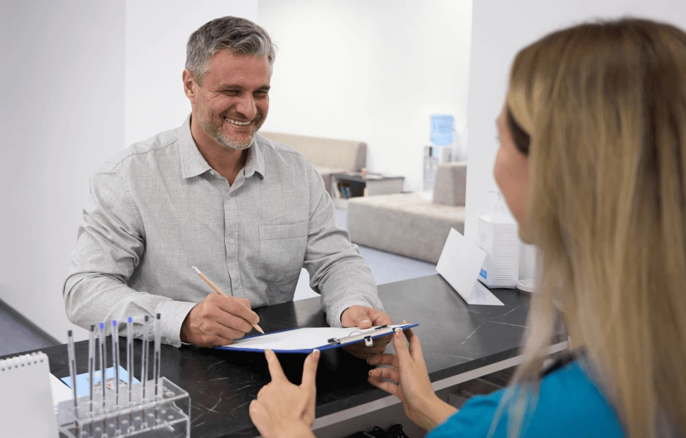a dental patient filling in a finance form
